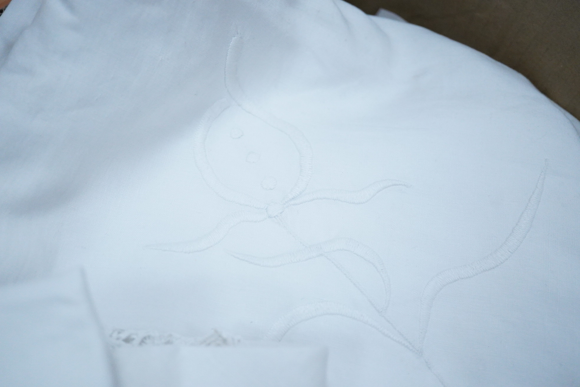 An ornate pineapple linen table cloth - 220cm x 190cm and a similar tea cosy, together with a collection of crochet edged, embroidered and cutwork table linens.